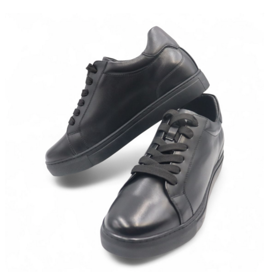 Pair of black sneakers on a white background
