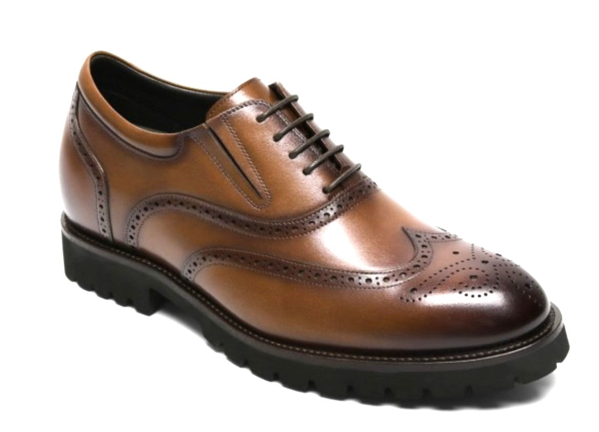 Brown leather brogue shoe on a white background